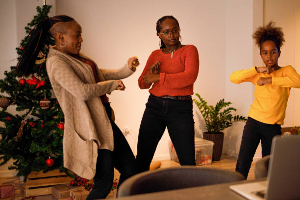 Tap tok Three female members of an African American family have lots of fun dancing Tik Tok routines on Christmas day. moving image stock pictures, royalty-free photos & images