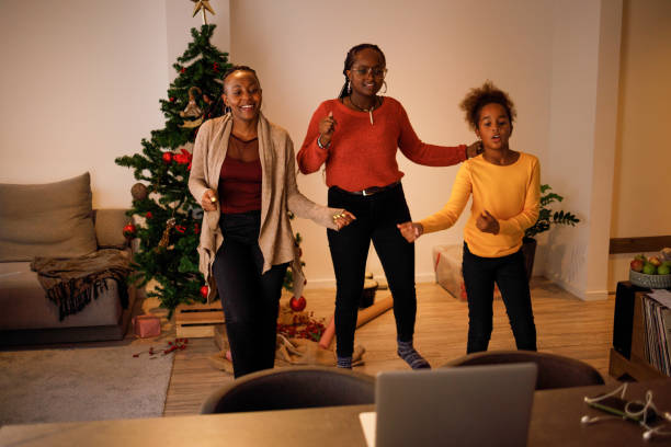 Tap tok Three female members of an African American family have lots of fun dancing Tik Tok routines on Christmas day. moving image stock pictures, royalty-free photos & images