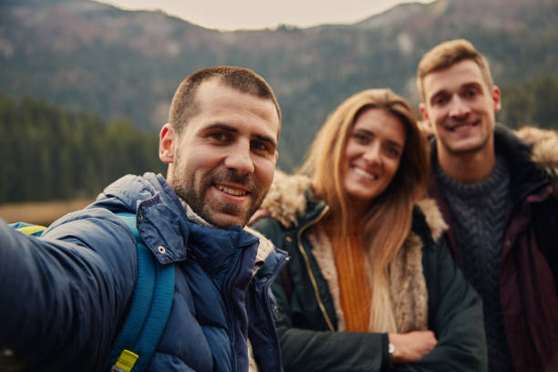 istock Cheerful Friends Taking Selfie On Hiking 1287825484