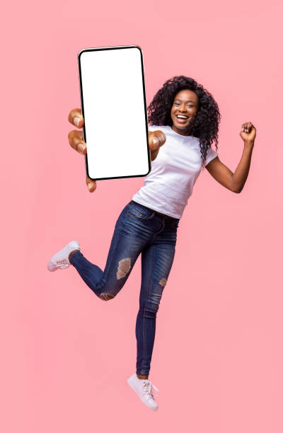 istock Excited black lady holding smartphone, jumping up 1287828637