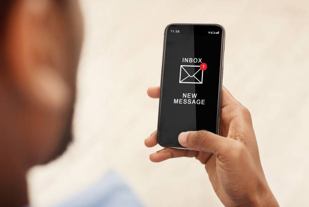 istock African Man Using Smartphone Reading Email Message Indoors, Cropped 1287828722