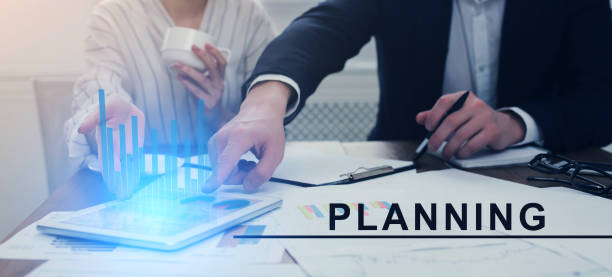 istock Business Planning. Two Partners Using Digital Tablet In Office Analyzing Economical Growth 1287828731