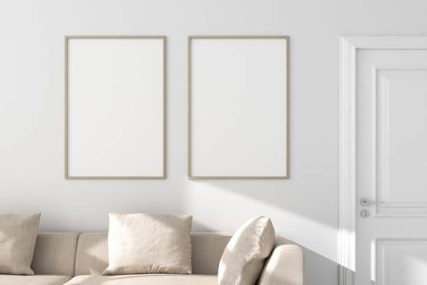 Two vertical picture frames mockup (70x100cm each) with sofa, wall and door. Sunlight. Two vertical picture frames mockup (70x100cm each) with sofa, wall and door. Sunlight. leaning photos stock pictures, royalty-free photos & images