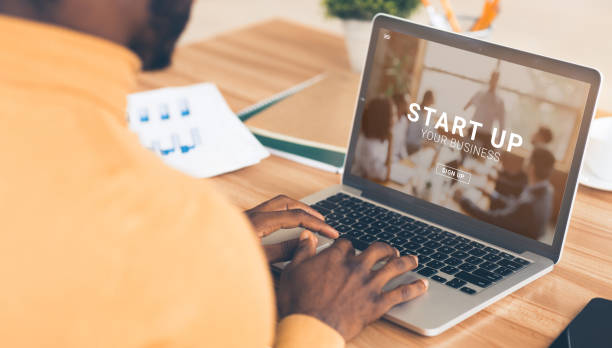 istock Black entrepreneur using online START UP YOUR BUSINESS platform on his laptop, panorama 1287829377