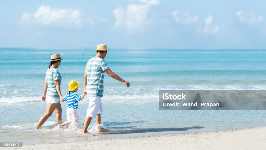 Happy family summer sea beach vacation. Asia young people lifestyle travel enjoy fun and relax leisure destination in holiday. Travel and Family Concept Beach Stock Photo