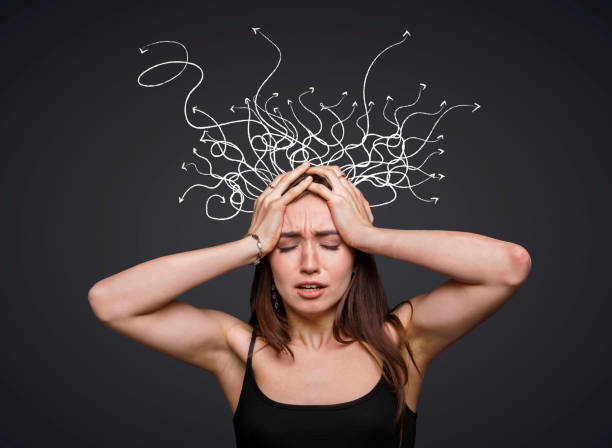 istock Desperate young woman holding her head, overwhelmed by various thoughts, creative collage 1287829471