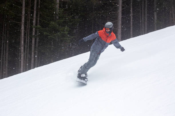 istock The snowboarder goes down the ski slope. 1287829993
