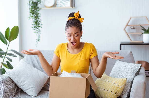istock Angry black woman unpacking wrong box, delivery mistake 1287832319