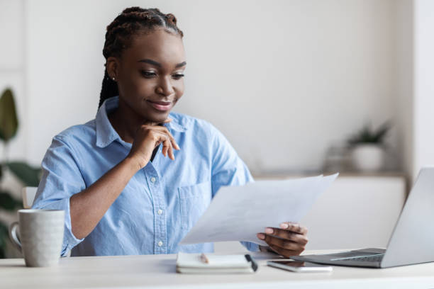 istock Ambitious Black Female Entrepreneur Working With Business Documentation In Office 1287832386