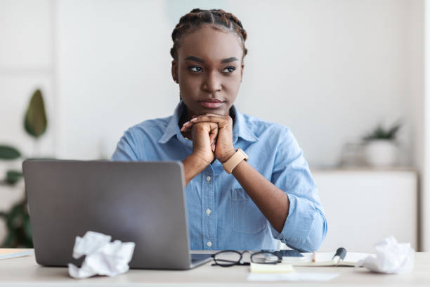 istock Inspiration Problem. Thoughtful black freelancer woman sitting at workplace in home office 1287832441