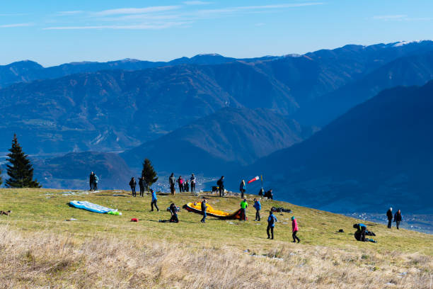 paragliders prepare to launch from the top of mount avena, dolomiti bellunesi national park, belluno, italy - beauty in nature belluno clear sky color image imagens e fotografias de stock