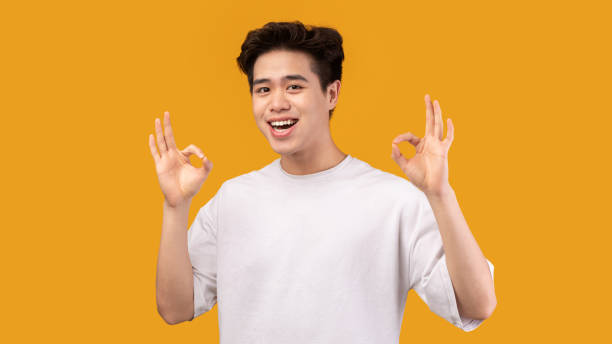istock Happy asian man gesturing okay and smiling 1287835862