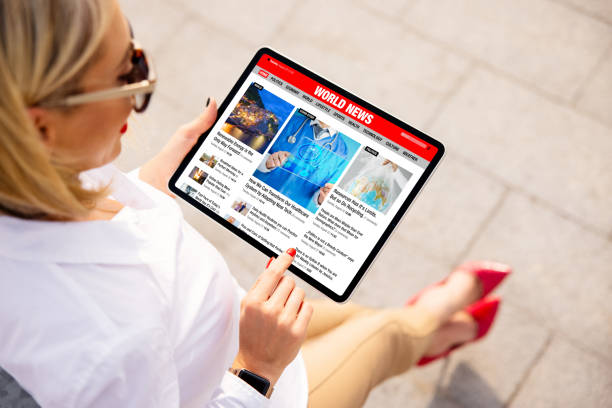 istock Woman reading news online on tablet 1287836043