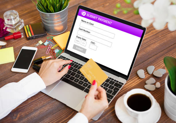 istock Woman entering credit card data and submitting payment online 1287836046