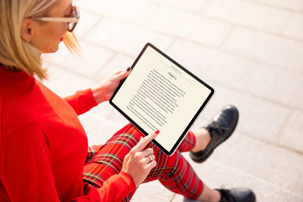 Woman reading a book on tablet