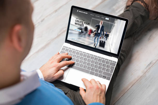 istock Man creating website for his business on laptop 1287836201