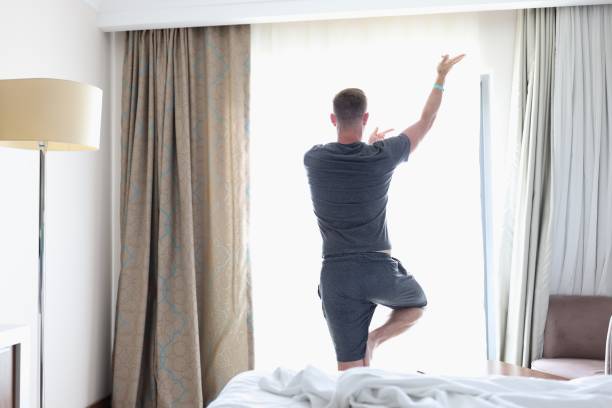 istock Man in gray suit stand near window in pose. 1287837907