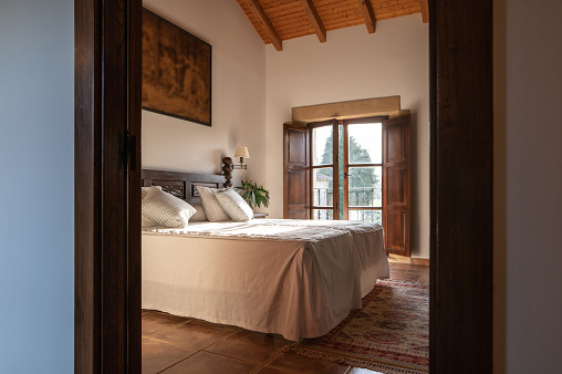 A beautiful bedroom with wooden elements and vintage looks