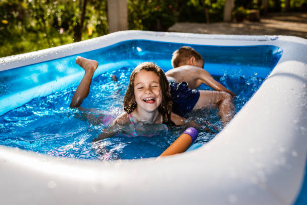 istock Children games in swimming pool 1287838441