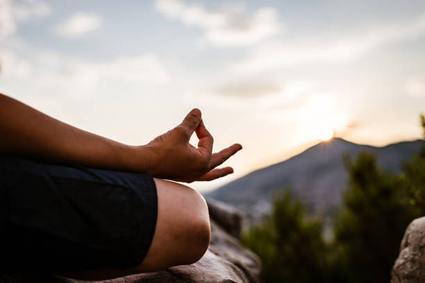 istock Young boy preforms yoga in mountains at sunset 1287838718