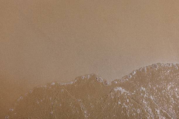 istock Smooth fine sand and clear water with bubbles. 1287838820