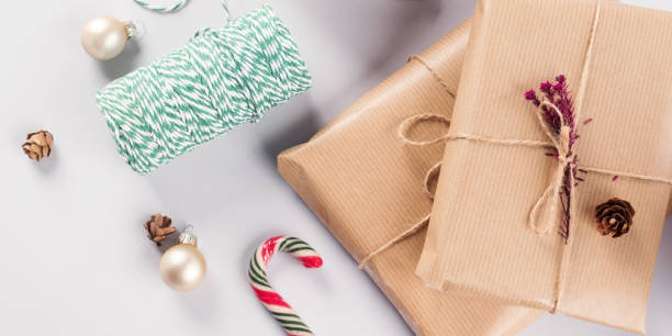 istock Xmas wrapped gifts stack and green twine 1287840635