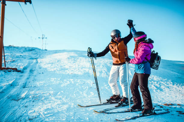 istock High Five By Male Skier And His Sister 1287842580