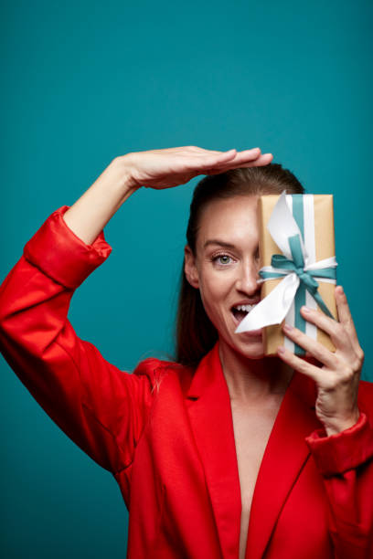 istock One woman making a fun gesture with a gift. 1287844916