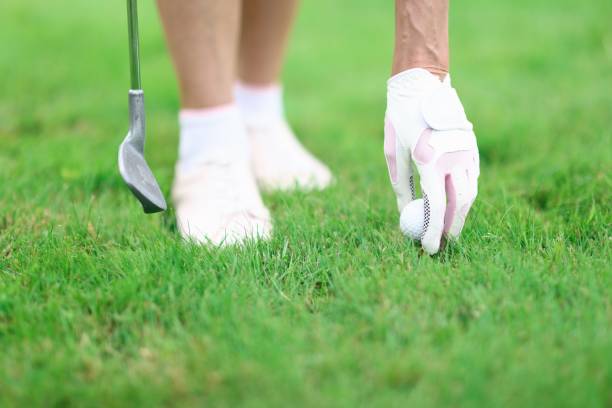 istock Golfer fixes golf ball and holds golf club in his hand. 1287846901