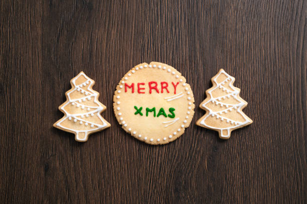 istock Top view of decorated Christmas tree cookie on wooden table background with copy space. 1287846956