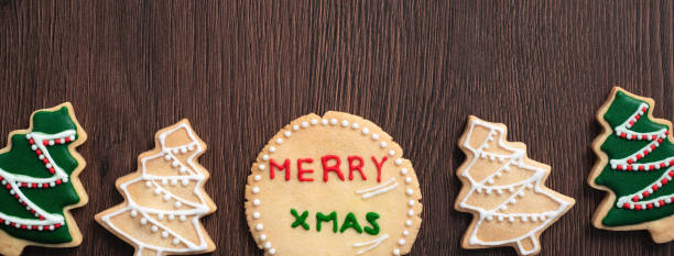 istock Top view of decorated Christmas tree cookie on wooden table background with copy space. 1287846992