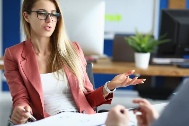 istock Businesswoman in office communicates with colleague at work. 1287847018