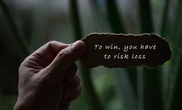 istock Hands Holding Torn paper with motivational quote and blurred dark background 1287850001