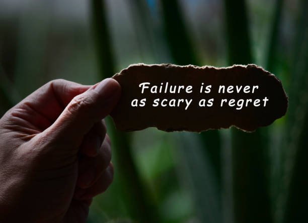 istock Hands Holding Torn paper with motivational quote and blurred dark background 1287850022