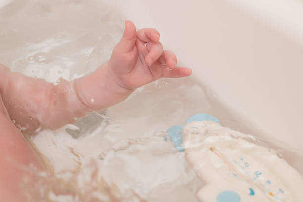 istock Cute baby having bath in white tub 1287850282