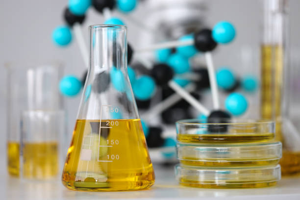 glas-reagenzgläser mit gelbviskosem flüssigkeitsständer auf dem tisch in chemischer labor-nahaufnahme - nahrungsmittelzusatz stock-fotos und bilder