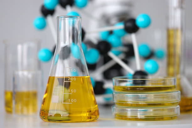 Glass test tubes with yellow viscous liquid stand on table in chemical laboratory closeup Glass test tubes with yellow viscous liquid stand on table in chemical laboratory closeup. Checking the quality of petroleum products refining concept. food additive stock pictures, royalty-free photos & images