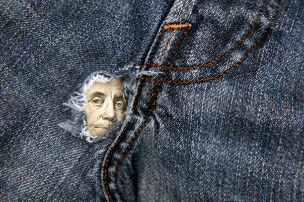 Benjamin Franklin's eyes on a hundred-dollar bill Benjamin Franklin's eyes on a hundred-dollar bill, with holes in his pants, background, close-up the collapse of the American economy hole in pants stock pictures, royalty-free photos & images