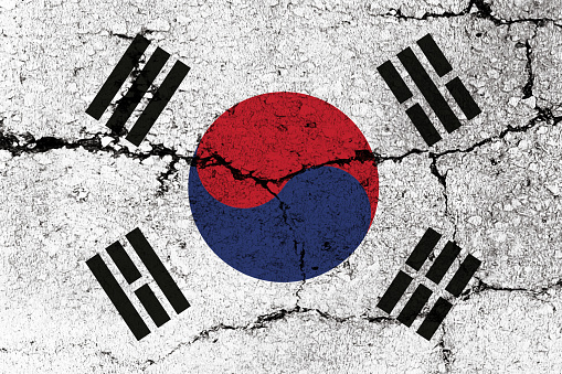 South Korean Flag on cracked wall background.