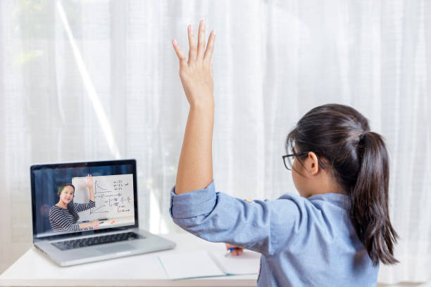 istock Asian little girl student learning via internet online class from school teacher duling covid-19 outbreak. Man teaching math by whiteboard. Homeschool learn from home concept 1287857432