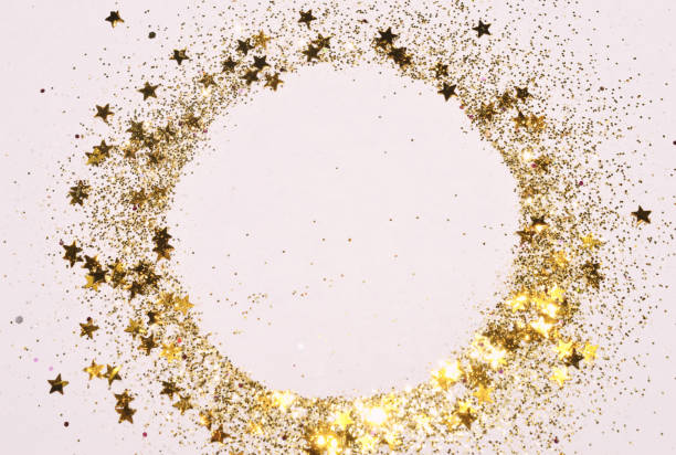 istock Round frame with gold glitter and glittering stars on light gray background. 1287859395