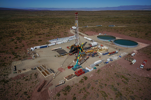 Vaca Muerta, Argentina, December 20, 2015: Extraction of unconventional oil. Battery of pumping trucks for hydraulic fracturing (Fracking).