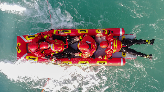 San Rafael, Argentina, november 6, 2020: firefighters in water rescue drill, using canoe and special suits. Aerial view from drone
