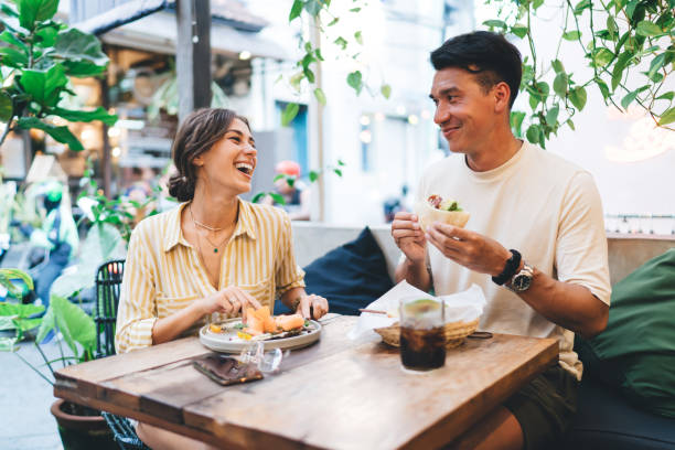 istock Diverse couple having fun at table in cafe 1287864060