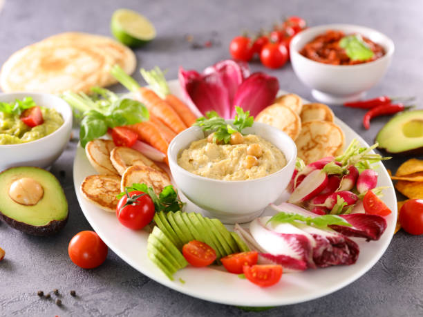 istock assorted of fresh vegetables and dips- hummus and raw vegetable-healthy eating 1287865363
