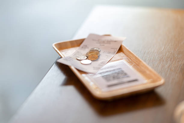 istock Food bills and change are placed on the dining table. 1287865865