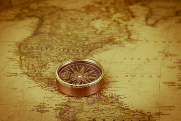 istock Compass on a vintage world map. Retro style 1287866409