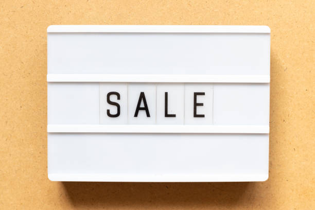 istock Lightbox with word sale on wood background 1287867740
