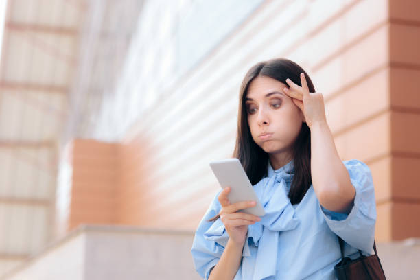 istock Unhappy Woman Receiving Odd Text Message 1287868790
