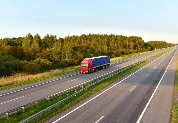 istock Truck with semi-trailer driving along highway 1287870668
